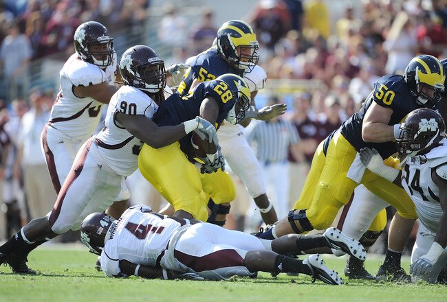 JACKSONVILLE, FL - JANUARY 01:  Pernell McPhee #90 of Mississippi State tackles Fitzgerald Toussaint # 28 of the Michigan Wolverines during the Gator Bowl at EverBank Field on January 1, 2011 in Jacksonville, Florida  (Photo by Rick Dole/Getty Images)