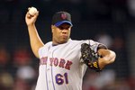 PHOENIX - AUGUST 11:  Starting pitcher Livan Hernandez #61 of the New York Mets pitches against the Arizona Diamondbacks during the major league baseball game at Chase Field on August 11, 2009 in Phoenix, Arizona. The Diamondbacks defeated the Mets 6-2.   (Photo by Christian Petersen/Getty Images)