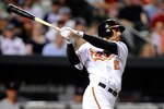 BALTIMORE - MAY 01:  Nick Markakis #21 of the Baltimore Orioles hits a home run in the sixth inning against the Boston Red Sox at Camden Yards on May 1, 2010 in Baltimore, Maryland.  (Photo by Greg Fiume/Getty Images)