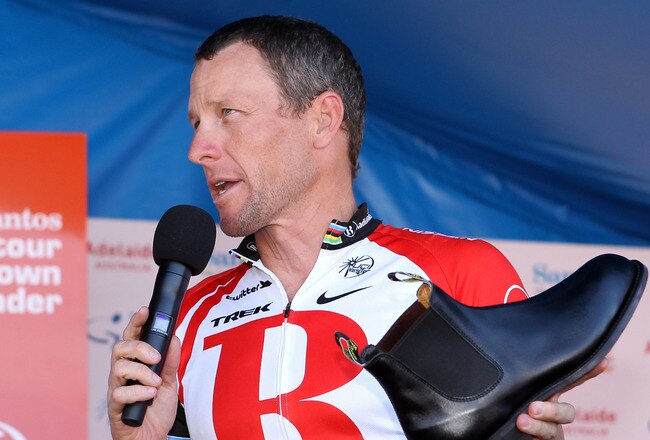 ADELAIDE, AUSTRALIA - JANUARY 23:  Lance Armstrong of the USA and Team Radio Shack holds a RM Williams shoe that is made locally in South Australia and was a presented to him as a gift by the Premier of South Australia, Mike Rann, after Stage Six of the 2011 Tour Down Under on January 23, 2011 in Adelaide, Australia.  (Photo by Morne de Klerk/Getty Images)
