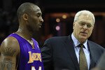CHARLOTTE, NC - FEBRUARY 14:  Head coach Phil Jackson talks to Kobe Bryant #24 of the Los Angeles Lakers during their game against the Charlotte Bobcats at Time Warner Cable Arena on February 14, 2011 in Charlotte, North Carolina. NOTE TO USER: User expressly acknowledges and agrees that, by downloading and/or using this Photograph, User is consenting to the terms and conditions of the Getty Images License Agreement.  (Photo by Streeter Lecka/Getty Images)