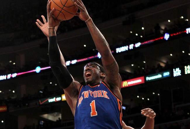 LOS ANGELES, CA - JANUARY 09:  Amar'e Stoudemire #1 of the New York Knicks goes up for a shot over Andrew Bynum #17 of the Los Angeles Lakers at Staples Center on January 9, 2011 in Los Angeles, California.  The Lakers won 109-87.   NOTE TO USER: User expressly acknowledges and agrees that, by downloading and or using this photograph, User is consenting to the terms and conditions of the Getty Images License Agreement.  (Photo by Stephen Dunn/Getty Images)