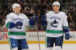 DENVER, CO - JANUARY 18:  Christian Ehrhoff #5 and Alexander Edler #23 of the Vancouver Canucks celebrate a goal against the Colorado Avalanche at the Pepsi Center on January 18, 2011 in Denver, Colorado. The Avalanche defeated the Canucks 4-3 in overtime.  (Photo by Doug Pensinger/Getty Images)