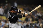 LOS ANGELES, CA - SEPTEMBER 17:  Clint Barmes #12 of the Colorado Rockies hits a single in the eighth inning against the Los Angeles Dodgers at Dodger Stadium on September 17, 2010 in Los Angeles, California.  (Photo by Lisa Blumenfeld/Getty Images)