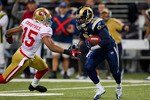 ST. LOUIS, MO - DECEMBER 26: Oshiomogho Atogwe #21 of the St. Louis Rams returns an interception against Michael Crabtree #15 of the San Francisco 49ers at the Edward Jones Dome on December 26, 2010 in St. Louis, Missouri. The Rams beat the 49ers 25-17. (Photo by Dilip Vishwanat/Getty Images)