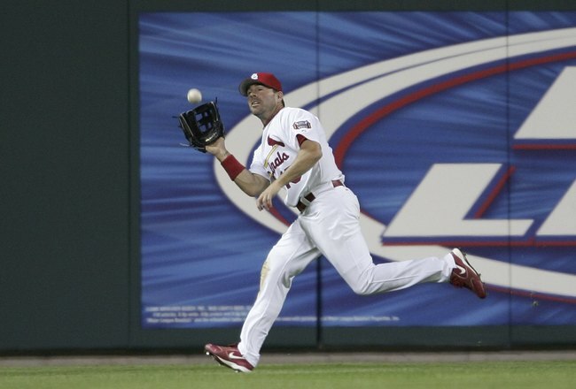 ST. LOUIS, MISSOURI - APRIL 12:  Jim Edmonds #15 of the St. Louis Cardinals makes the catch for the last out of the game against the Milwaukee Brewers on April 12, 2006 at Busch Stadium in St. Louis, Missouri. The Cardinals defeated the Brewers 8-3.  (Photo by Elsa/Getty Images)