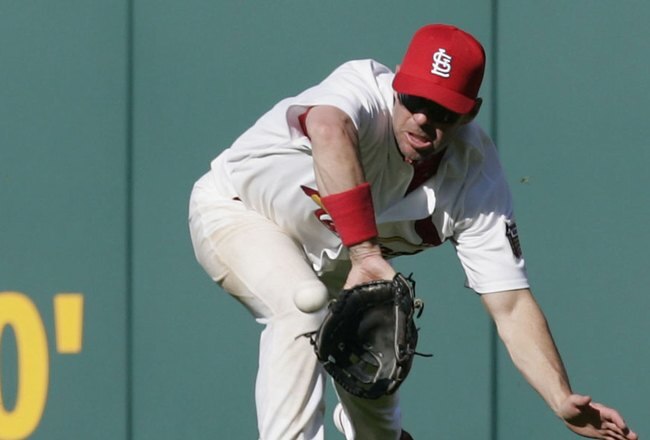 ST. LOUIS, MO - APRIL 10:   Jim Edmonds #15 of the St. Louis Cardinals makes a diving catch against the Milwaukee Brewers at Busch Stadium on April 10, 2006 in St. Louis, Missouri.  The Cards beat the Brewers 6-4.   (Photo by Dilip Vishwanat/Getty Images)