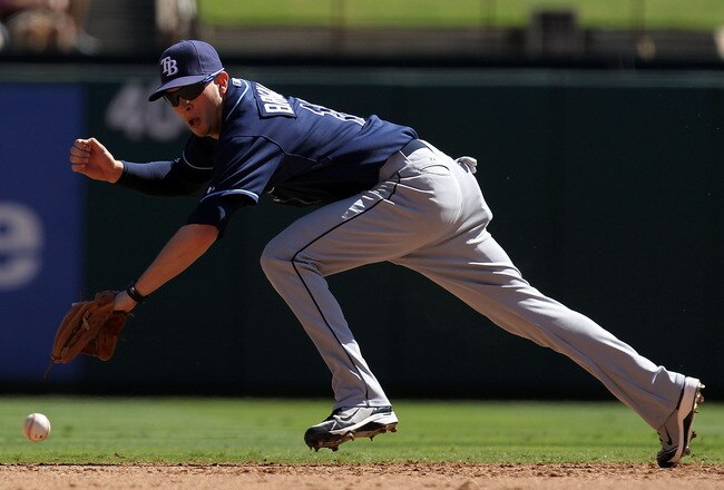 ARLINGTON, TX - OCTOBER 10:  Shortstop Reid Brignac #15 dives for a single by Michael Young #10 of the Texas Rangers during game 4 of the ALDS at Rangers Ballpark in Arlington on October 10, 2010 in Arlington, Texas.  (Photo by Ronald Martinez/Getty Images)