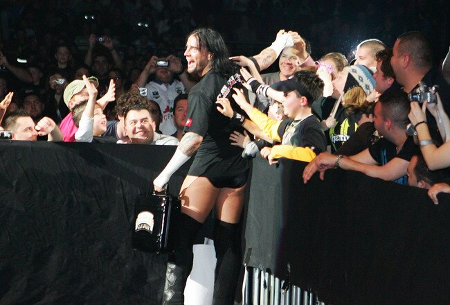 SYDNEY, AUSTRALIA - JUNE 15:  CM Punk celebrates with fans before facing Shelton Benjamin during WWE Smackdown at Acer Arena on June 15, 2008 in Sydney, Australia.  (Photo by Gaye Gerard/Getty Images)