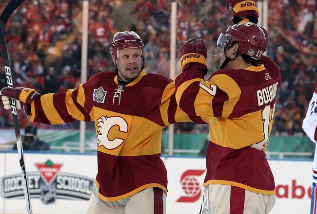 CALGARY, AB - FEBRUARY 20:  Rene Bourque #17 (R) of the Calgary Flames scores a power play goal at 8:09 of the first period and is joined by Olli Jokinen #13 (L) in first period action against the Montreal Canadiens during the 2011 NHL Heritage Classic Game at McMahon Stadium on February 20, 2011 in Calgary, Alberta, Canada.  (Photo by Mike Ridewood/Getty Images)