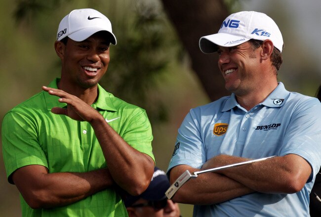 DUBAI, UNITED ARAB EMIRATES - FEBRUARY 11:  Tiger Woods of the USA shares a joke with Lee Westwood of England during the second round the Omega Dubai Desert Classic on the Majlis course at the Emirates Golf Club on February 11, 2011 in Dubai, United Arab Emirates.  (Photo by Ross Kinnaird/Getty Images)