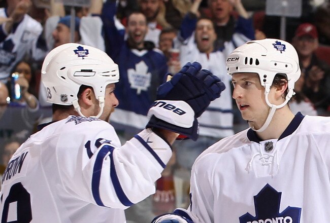 GLENDALE, AZ - JANUARY 13:  Colby Armstrong #9 of the Toronto Maple Leafs celebrates with teammate Mike Brown #18 after Armstrong scored a third period goal against the Phoenix Coyotes during the NHL game at Jobing.com Arena on January 13, 2011 in Glendale, Arizona. The Coyotes defeated the Maple Leafs 5-1. (Photo by Christian Petersen/Getty Images)