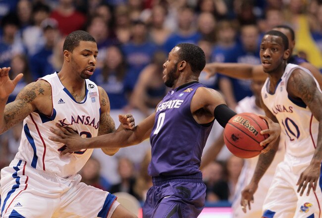 LAWRENCE, KS - JANUARY 29:  Jacob Pullen #0 of the Kansas State Wildcats controls the ball as Marcus Morris #22 of the Kansas Jayhawks defends during the game on January 29, 2011 at Allen Fieldhouse in Lawrence, Kansas.  (Photo by Jamie Squire/Getty Images)