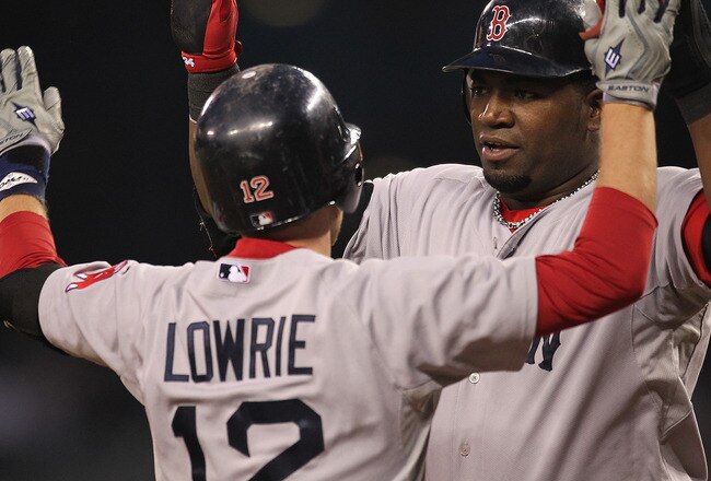 SEATTLE - SEPTEMBER 14:  Jed Lowrie #12 of the Boston Red Sox is congratulated by David Ortiz #34 after hitting a two-run home run against the Seattle Mariners at Safeco Field on September 14, 2010 in Seattle, Washington. (Photo by Otto Greule Jr/Getty Images)