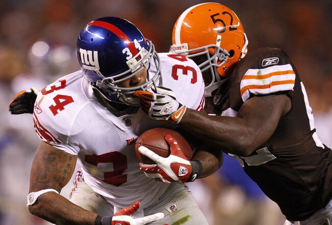 CLEVELAND - OCTOBER 13:  Derrick Ward #34 of the New York Giants gets pulled down by the face mask by D'Qwell Jackson #52 of the Cleveland Browns on October 13, 2008 at Cleveland Browns Stadium in Cleveland, Ohio. Cleveland won the game 35-14.  (Photo by Gregory Shamus/Getty Images)