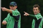 BELFAST, UNITED KINGDOM - JUNE 24:  Trent Johnstone (L) and Kyle McCallan of Ireland make an adjustment to the field during the One Day International match between Ireland and South Africa at the Civil Service Cricket Club in Stormont on June 24, 2007 in Belfast, Northern Ireland.  (Photo by Hamish Blair/Getty Images)