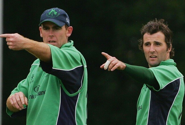 BELFAST, UNITED KINGDOM - JUNE 24:  Trent Johnstone (L) and Kyle McCallan of Ireland make an adjustment to the field during the One Day International match between Ireland and South Africa at the Civil Service Cricket Club in Stormont on June 24, 2007 in Belfast, Northern Ireland.  (Photo by Hamish Blair/Getty Images)