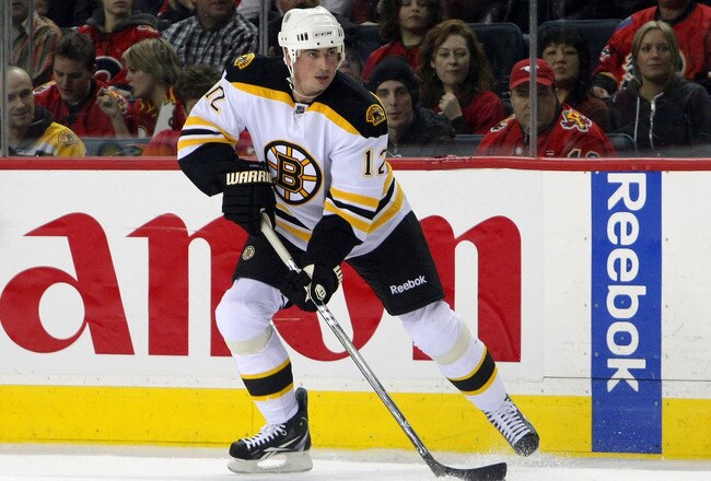 CALGARY,CANADA - FEBRUARY 22:  Tomas Kaberle #12 of the Boston Bruins carries the puck against the Calgary Flames during their NHL game at Scotiabank Saddledome, February 22,2011 in Calgary, Alberta, Canada.  (Photo By Dave Sandford/Getty Images)