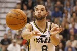SALT LAKE CITY, UT - DECEMBER 8:  Deron Williams #8 of the Utah Jazz passes the ball during a game against the Miami Heat during the second half of an NBA game December 8, 2010 at Energy Solutions Arena in Salt Lake City, Utah. The Heat beat the Jazz 111-98. NOTE TO USER:  User expressly acknowledges and agrees that, by downloading and or using this photograph, User is consenting to the terms and conditions of the Getty Images License Agreement.  (Photo by George Frey/Getty Images)