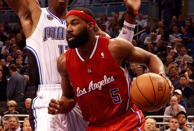 ORLANDO, FL - FEBRUARY 08:  Baron Davis #5 of the Los Angeles Clippers is guarded by Dwight Howard #12 of the Orlando Magic during the game at Amway Arena on February 8, 2011 in Orlando, Florida.  NOTE TO USER: User expressly acknowledges and agrees that, by downloading and or using this Photograph, user is consenting to the terms and conditions of the Getty Images License Agreement.  (Photo by Sam Greenwood/Getty Images)