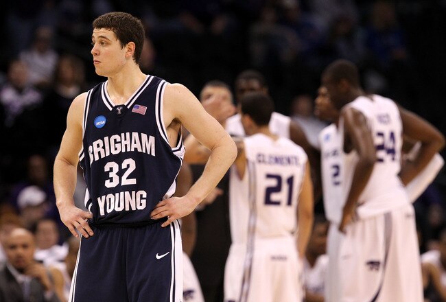 OKLAHOMA CITY - MARCH 20:  Jimmer Fredette #32 of the Brigham Young Cougars looks on as the Kansas State Wildcats huddle up in the background during the second round of the 2010 NCAA men's basketball tournament at Ford Center on March 20, 2010 in Oklahoma City, Oklahoma.  (Photo by Ronald Martinez/Getty Images)