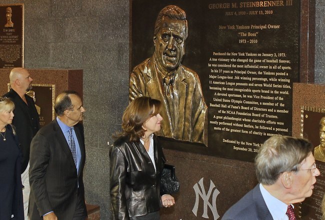 NEW YORK - SEPTEMBER 20:  Former manager of the New York Yankees Joe Torre (3rd L) walks past the monument of late owner George Steinbrenner with his wife Ali prior to the game against the Tampa Bay Rays on September 20, 2010 at Yankee Stadium in the Bronx borough of New York City.  (Photo by Jim McIsaac/Getty Images)