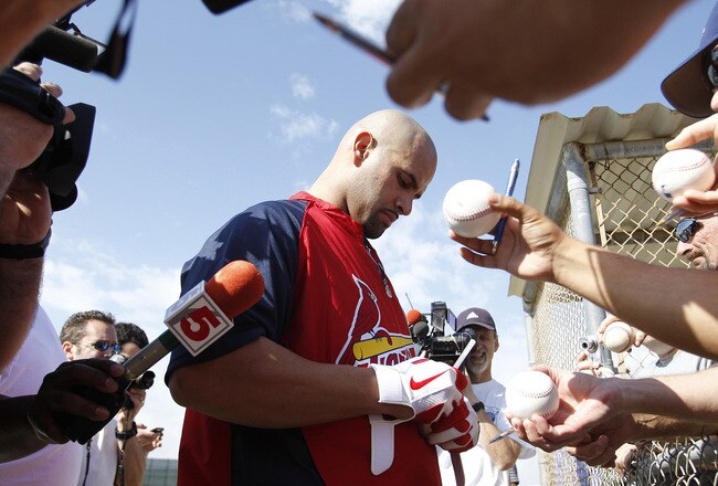 JUPITER, FL - FEBRUARY 17: Albert Pujols #5 #5 of the St. Louis Cardinals signs autographs for fans at Roger Dean Stadium on February 17, 2011 in Jupiter, Florida. (Photo by Joel Auerbach/Getty Images)