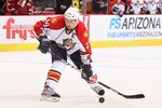 GLENDALE, AZ - DECEMBER 04:  Bryan McCabe #24 of the Florida Panthers skates with the puck  during the NHL game against the Phoenix Coyotes at Jobing.com Arena on December 4, 2010 in Glendale, Arizona.  The Panthers defeated the Coyotes 2-1 in an overtime shoot out.  (Photo by Christian Petersen/Getty Images)