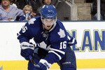 TORONTO, CANADA - JANUARY 22:  Clarke MacArthur #16 of the Toronto Maple Leafs grabs a loose puck during game action at the Air Canada Centre against the Washington Capitals January 22, 2011 in Toronto, Ontario, Canada. (Photo by Abelimages/Getty Images)