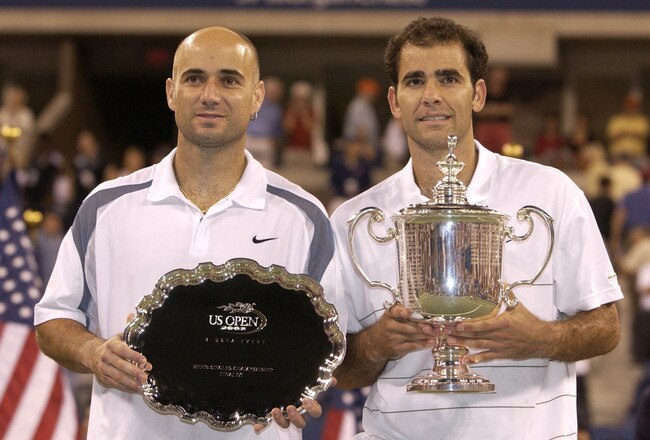 FLUSHING, NY - SEPTEMBER 8: Andre Agassi and Pete Sampras pose for photographers after their match during the final of the US Open September 8, 2002 at the USTA National Tennis Center in Flushing Meadows Corona Park in Flushing, New York.  (Photo by Ezra Shaw/Getty Images)