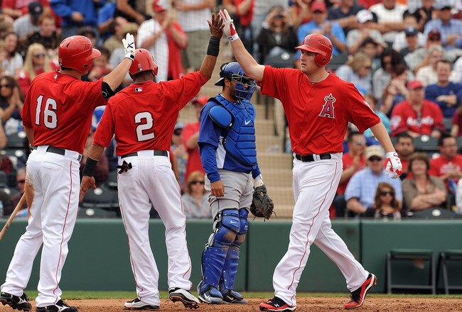 TEMPE, AZ - FEBRUARY 26:  Mark Trumbo #44 of the Los Angeles Angels of Anaheim gets high fives after hitting a two run home run against the Los Angeles Dodgers at Tempe Diablo Stadium on February 26, 2011 in Tempe, Arizona.  (Photo by Norm Hall/Getty Images)