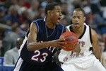 BUFFALO, NY - MARCH 18:  Brian Woodson #23 of the Liberty University Flames moves the ball against a St Joseph's Hawks defender during the first round game of the NCAA Basketball Tournament on March 18, 2004 at HSBC Arena in Buffalo, New York. The Hawks won 82-63. (Photo by Rick Stewart/Getty ImagesI)