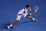 MELBOURNE, AUSTRALIA - JANUARY 27:  Novak Djokovic of Serbia plays a backhand in his semifinal match against Roger Federer of Switzerland during day eleven of the 2011 Australian Open at Melbourne Park on January 27, 2011 in Melbourne, Australia.  (Photo by Quinn Rooney/Getty Images)
