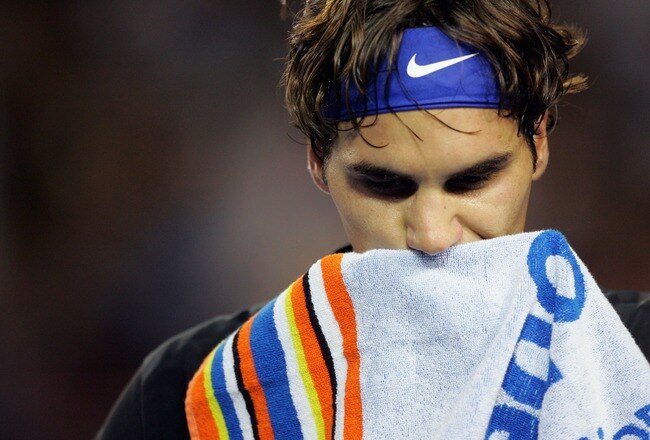 MELBOURNE, AUSTRALIA - JANUARY 25:  Roger Federer of Switzerland wipes his face between games during his semi-final match against Novak Djokovic of Serbia on day twelve of the Australian Open 2008 at Melbourne Park on January 25, 2008 in Melbourne, Australia.  (Photo by Ezra Shaw/Getty Images)