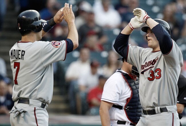 CLEVELAND, OH- APRIL 30: Joe Mauer #7 congratulates Justin Morneau #33 of the Minnesota Twins after scoring during the game against the Cleveland Indians on April 30, 2010 at Progressive Field in Cleveland, Ohio.  (Photo by Jared Wickerham/Getty Images)