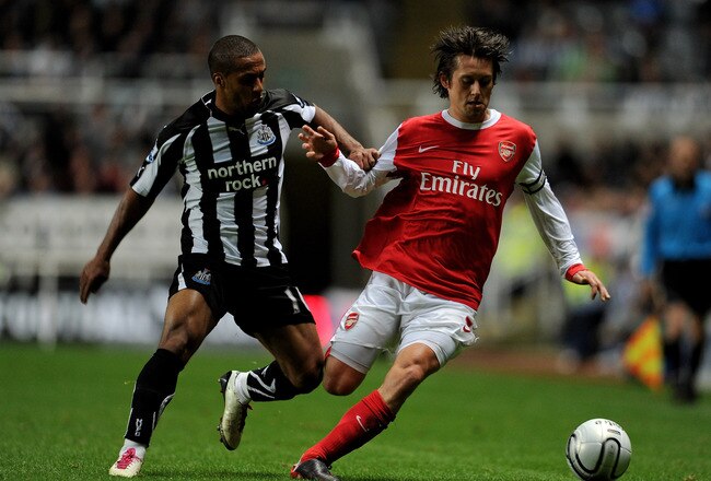 NEWCASTLE UPON TYNE, ENGLAND - OCTOBER 27:  Tomas Rosicky of Arsenal competes for the ball with Wayne Routledge of Newcastle United during the Carling Cup Fourth Round match between Newcastle United and Arsenal at St James' Park on October 27, 2010 in Newcastle, England.  (Photo by Michael Regan/Getty Images)