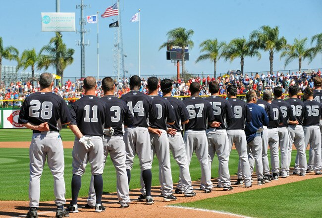 CLEARWATER, FL - FEBRUARY 27:  Manager Joe Girardi #28 and players of the New York Yankees line up for pre-game introduction before play  against the Philadelphia Phillies February 27, 2011 at Bright House Field in Clearwater, Florida.  (Photo by Al Messerschmidt/Getty Images)