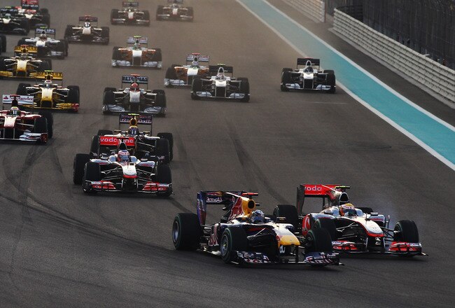 ABU DHABI, UNITED ARAB EMIRATES - NOVEMBER 14:  (L-R) Sebastian Vettel of Germany and Red Bull Racing leads from Lewis Hamilton of Great Britain and McLaren Mercedes into the first corner at the start of the Abu Dhabi Formula One Grand Prix at the Yas Marina Circuit on November 14, 2010 in Abu Dhabi, United Arab Emirates.  (Photo by Mark Thompson/Getty Images)