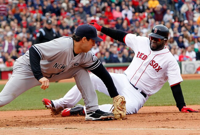 BOSTON - OCTOBER 3:  Mark Teixeira #25 of the New York Yankees executes the second out of a double play on base runner David Ortiz #34 of  the Boston Red Sox, who was caught off of first base, at Fenway Park, October 3, 2010, in Boston, Massachusetts. (Photo by Jim Rogash/Getty Images)
