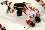 CHICAGO, IL - MARCH 02: Jarome Iginla #12 of the Calgary Flames hits the ice after colliding with Brent Seabrook of the Chicago Blackawks at the United Center on March 2, 2011 in Chicago, Illinois. (Photo by Jonathan Daniel/Getty Images)