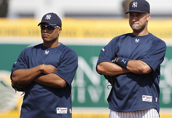 TAMPA, FL - FEBRUARY 20: Robinson Cano #24 Derek Jeter #2 and Jorge Posada #20 of the New York Yankees watch the action during the first full team workout of Spring Training on February 20, 2011 at the George M. Steinbrenner Field in Tampa, Florida. (Photo by Leon Halip/Getty Images)