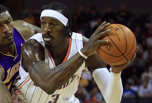 CHARLOTTE, NC - FEBRUARY 14:  Ron Artest #15 of the Los Angeles Lakers reaches for the ball against Gerald Wallace #3 of the Charlotte Bobcats during their game at Time Warner Cable Arena on February 14, 2011 in Charlotte, North Carolina. NOTE TO USER: User expressly acknowledges and agrees that, by downloading and/or using this Photograph, User is consenting to the terms and conditions of the Getty Images License Agreement.  (Photo by Streeter Lecka/Getty Images)
