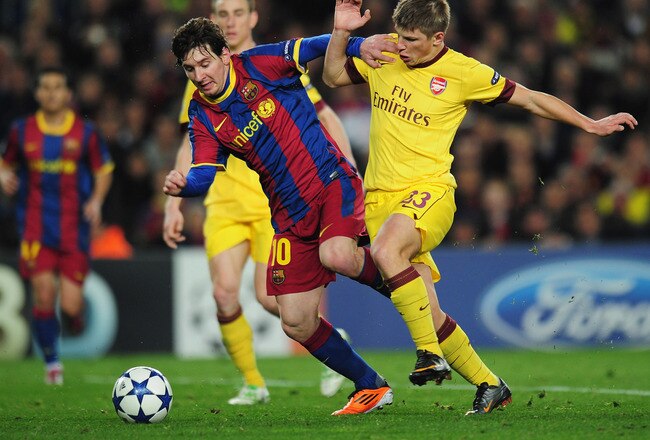 BARCELONA, SPAIN - MARCH 08:  Lionel Messi of Barcelona is tackled by Andrey Arshavin of Arsenal during the UEFA Champions League round of 16 second leg match between Barcelona and Arsenal at the Nou Camp Stadium on March 8, 2011 in Barcelona, Spain.  (Photo by Shaun Botterill/Getty Images)