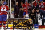 MONTREAL, CANADA - MARCH 8:  Members of the Montreal Canadiens medical staff tend to Max Pacioretty #67 of the Montreal Canadiens on a stretcher after being body checked by Zdeno Chara #33 of the Boston Bruins (not pictured) during the NHL game at the Bell Centre on March 8, 2011 in Montreal, Quebec, Canada.  (Photo by Richard Wolowicz/Getty Images)