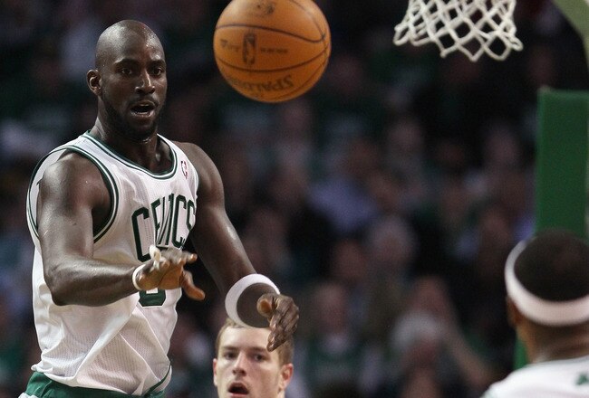 BOSTON, MA - MARCH 04: Kevin Garnett #5 of the Boston Celtics passes the ball to Paul Pierce #34 as David Lee #10 of the Golden State Warriors defends on March 4, 2011 at the TD Garden in Boston, Massachusetts.  The Celtics defeated the Warriors 107-103. NOTE TO USER: User expressly acknowledges and agrees that, by downloading and/or using this Photograph, User is consenting to the terms and conditions of the Getty Images License Agreement.  (Photo by Elsa/Getty Images)