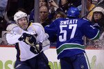 VANCOUVER, CANADA - JANUARY 26: David Legwand #11of the Nashville Predators reacts as he is hit by Lee Sweatt #57 of the Vancouver Canucks during the third period in NHL action on January 26, 2011 at Rogers Arena in Vancouver, British Columbia, Canada.  (Photo by Rich Lam/Getty Images)