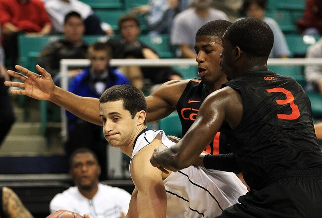 GREENSBORO, NC - MARCH 10:  Sammy Zeglinski #13 of the Virginia Cavaliers looks to pass against Malcolm Grant #3 and DeQuan Jones #31 of the Miami Hurricanes during the second half of the first round of the 2011 ACC men's basketball tournament at the Greensboro Coliseum on March 10, 2011 in Greensboro, North Carolina.  (Photo by Streeter Lecka/Getty Images)
