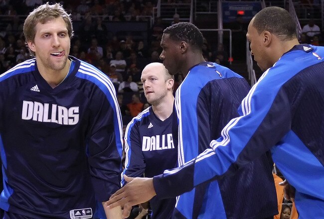 PHOENIX, AZ - FEBRUARY 17:  Dirk Nowitzki #41 of the Dallas Mavericks high fives teammates during introductions to the NBA game against the Phoenix Suns at US Airways Center on February 17, 2011 in Phoenix, Arizona.  NOTE TO USER: User expressly acknowledges and agrees that, by downloading and or using this photograph, User is consenting to the terms and conditions of the Getty Images License Agreement.  (Photo by Christian Petersen/Getty Images)