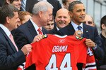 WASHINGTON, DC - MARCH 11:  U.S. President Barack Obama (R) is presented with a hockey jersey and Championship ring by Chicago Blackhawks President John McDonough (C) during an event on the south lawn of the White House on March 11, 2011 in Washington, DC.  Obama hosted the event to honor the Blackhawks for their 2010 Stanley Cup championship victory.  (Photo by Mark Wilson/Getty Images)