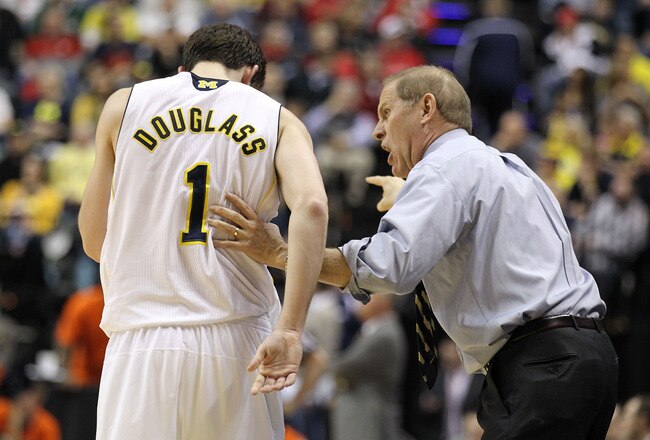 INDIANAPOLIS, IN - MARCH 11:  Head coach John Beilein of the Michigan Wolverines talks to Stu Douglass #1 against the Illinois Fighting Illini during the quarterfinals of the 2011 Big Ten Men's Basketball Tournament at Conseco Fieldhouse on March 11, 2011 in Indianapolis, Indiana.  (Photo by Andy Lyons/Getty Images)